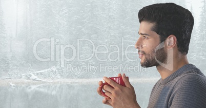 Man reflecting with cup in bright snow forest