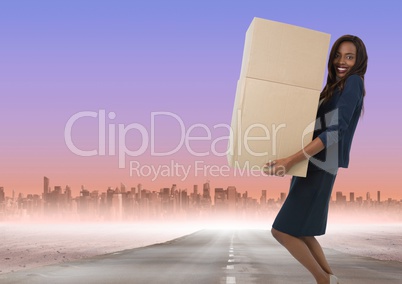 Businesswoman carrying boxes on road to city