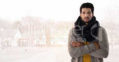 Man in Autumn with  with scarf and folded arms in bright housing estate
