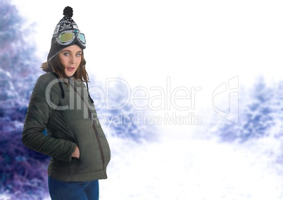 Woman wearing hat and coat in snow forest