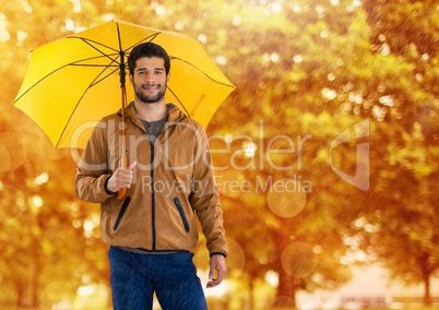 Man in Autumn with umbrella in forest