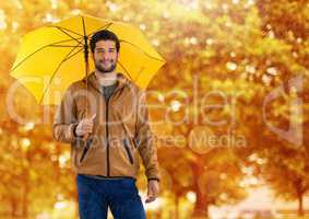 Man in Autumn with umbrella in forest