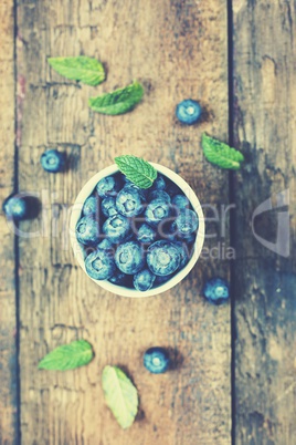 Blueberries on a wooden table. Country style. Top view