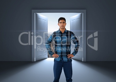 Businessman with hands on hips by open door to city