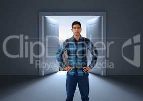 Businessman with hands on hips by open door to city