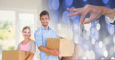 people moving boxes into new home with key