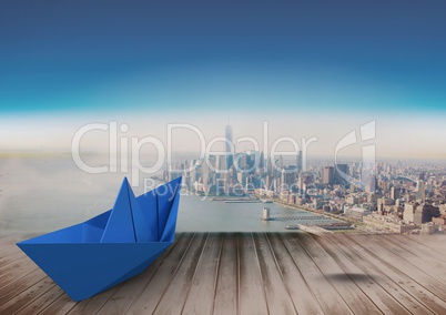 Paper boat over city