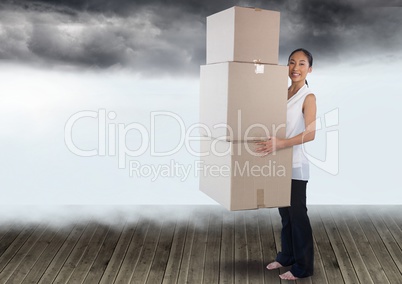 Businesswoman holding boxes with clouds