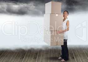 Businesswoman holding boxes with clouds