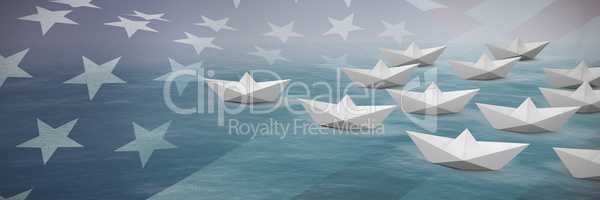 Composite image of paper boats arranged on white background