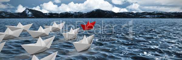 Composite image of paper boats arranged