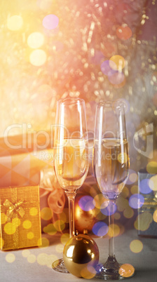 Champagne flutes and Christmas ornaments with gift