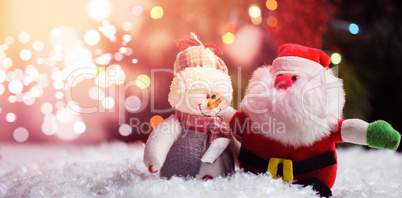 Santa claus and snowman on snow