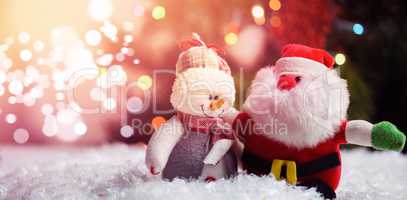 Santa claus and snowman on snow