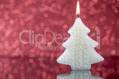Christmas tree candle light with reflection on red blurred bokeh