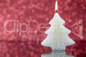 Christmas tree candle light with reflection on red blurred bokeh