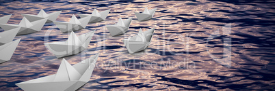 Composite image of graphic image of paper boats arranged