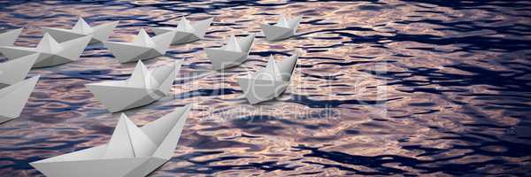 Composite image of graphic image of paper boats arranged