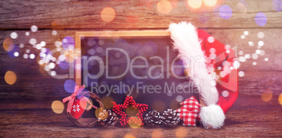 Decorations and Santa hat arranged on slate