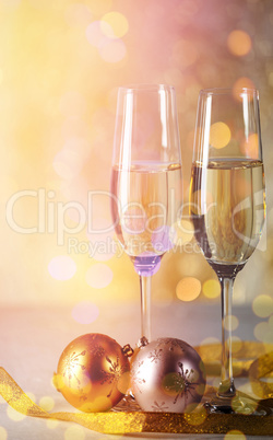 Champagne flutes with Christmas ornaments and ribbon