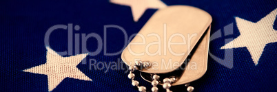 Close-up of dog tag pendant on flag