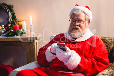 Santa claus sitting and using mobile phone Santa claus sitting and using mobile phone