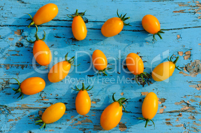 tomatoes on blue wooden surface