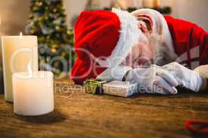 Santa claus sleeping at table at home
