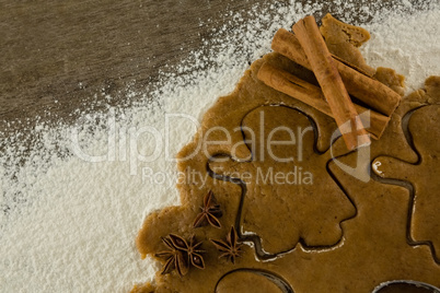 Gingerbread dough with flour, cookie cutter, anise and cinnamon
