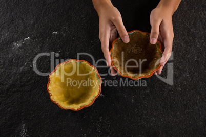 Woman holding tart dough on mold