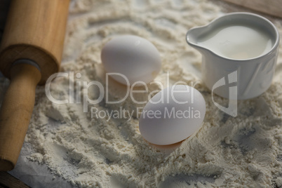 Flour, eggs and rolling pin placed over butter paper