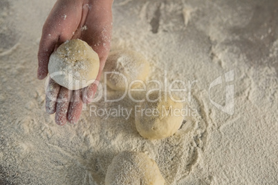 Hand holding a dough ball