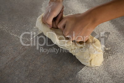 Woman kneading a dough