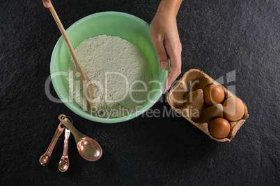 Woman mixing flour in bowl