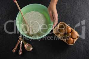 Woman mixing flour in bowl