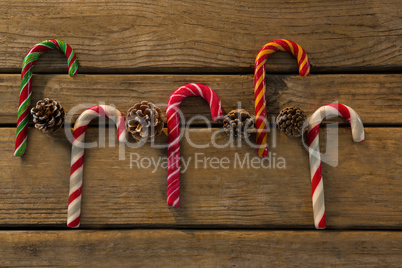 Directly above shot of colorful candy canes with pine cones