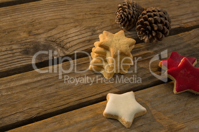 High angle view of star shaped cookies with pine cones on table