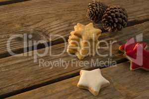 High angle view of star shaped cookies with pine cones on table