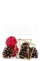 Pine cones and christmas decoration against white background