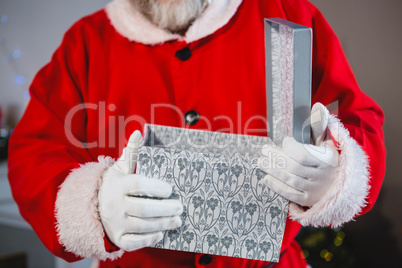 Santa claus opening the gift box