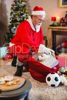 Santa claus listening music on mobile phone at home