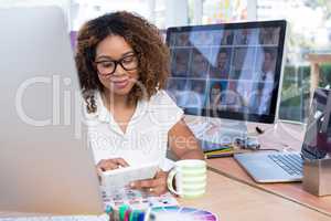 Female graphic designer using digital tablet in office