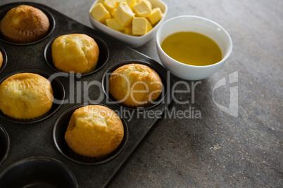 Cupcakes and cheese arranged on a concrete background