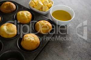 Cupcakes and cheese arranged on a concrete background