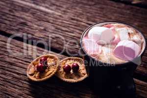 Cookies and hot chocolate on wooden plank