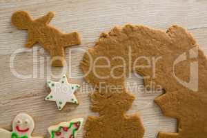 Gingerbread dough with star shapes on wooden table