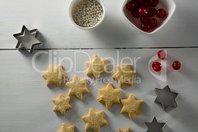 Red cherries in bowl with star shape cookies and cutter