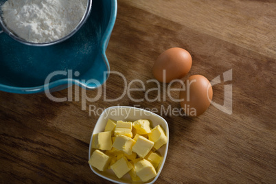 Flour in stainer with eggs and cheese