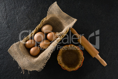 Eggs in wicker basket with dough