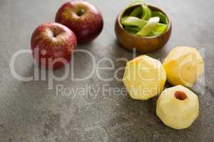 Peeled green apple and two red apple